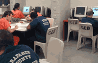 Picture of Inmates using computer lab and study area.
